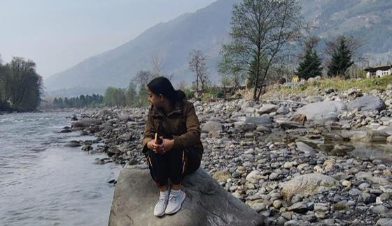 Content girl stating at river